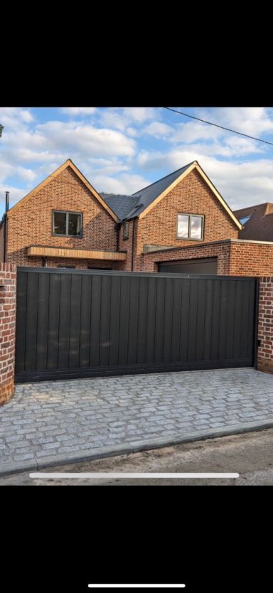 Black steel driveway gates with composite inserts